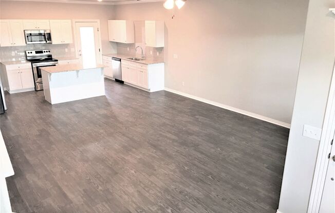 B3 (1-car) Living Dining open concept with laminate wood flooring