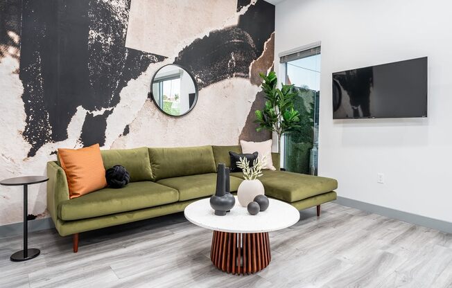 a living room with a geometric tile floor and a green couch
