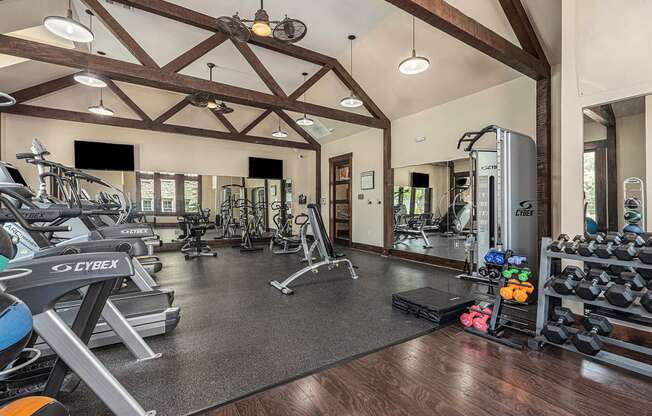 a gym with cardio equipment and weights