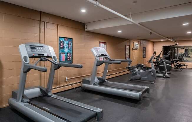 two treadmills and other exercise equipment in the gym of a building. Roseville, MN Rosedale Estates Apartments