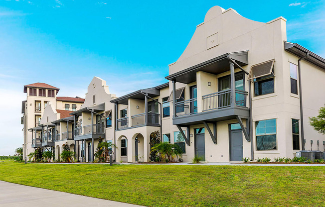 a row of houses on a grassy field