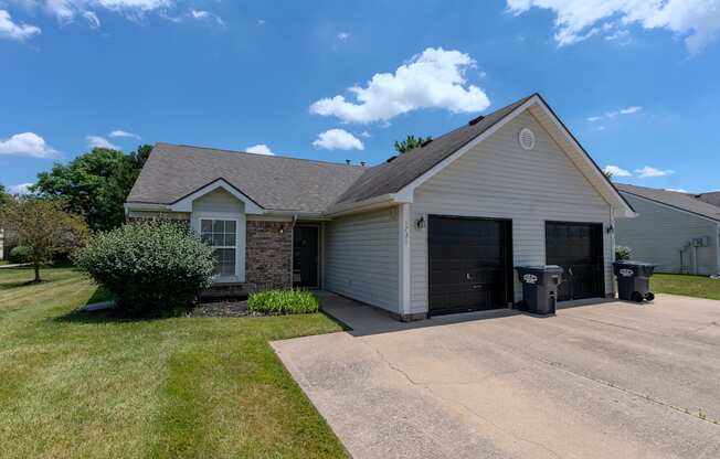 a white house with a driveway and a garage door