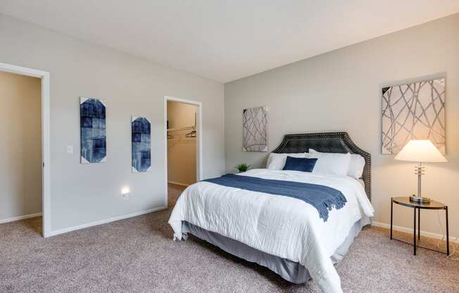 Carpeted Bedroom With Attached Walk-In Closet