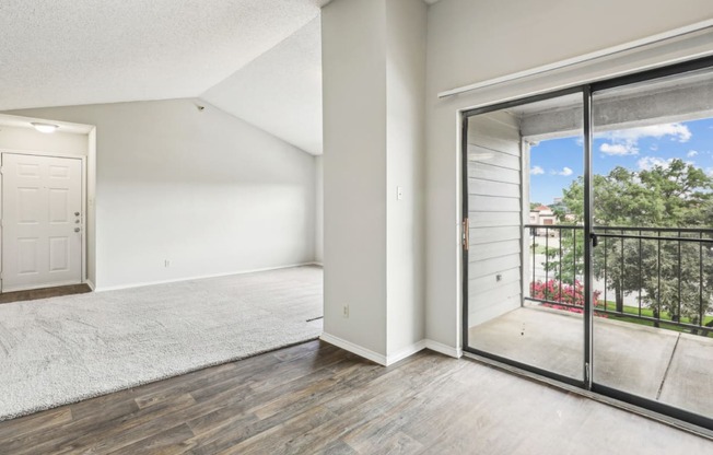 A3 floor plan living room with sliding glass doors to a balcony at Jefferson Creek Apartments in Irving, TX.