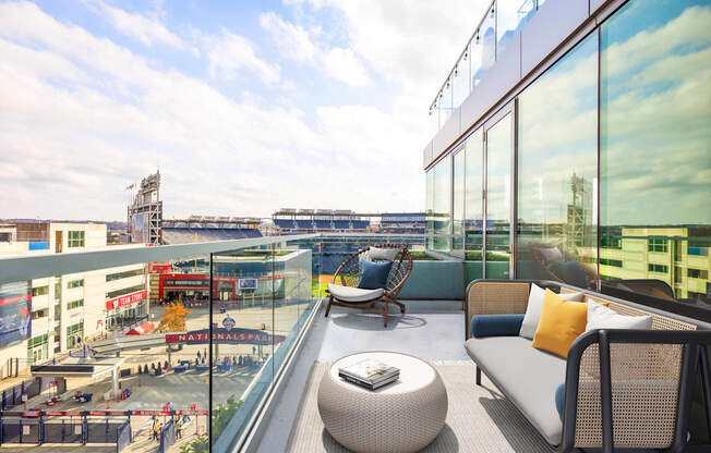 a balcony with a couch a chair and a table