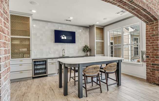 a kitchen with a large island and a brick wall