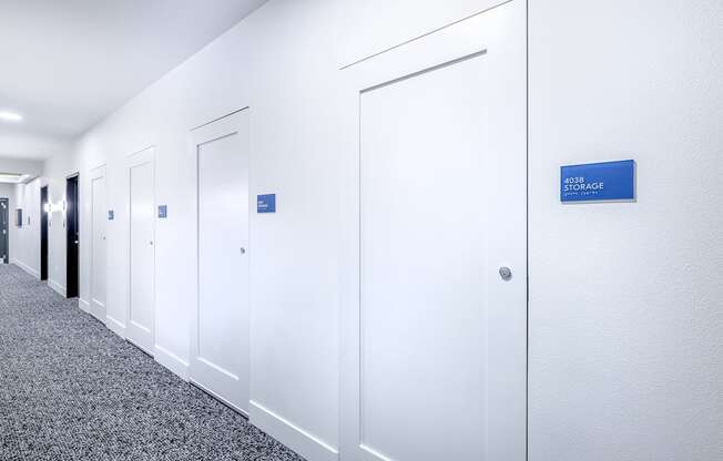 a row of white offices with a blue sign on the wall at Marina Square, WA 98337