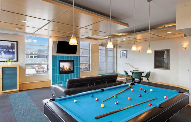 a games room with a pool table and a fireplace