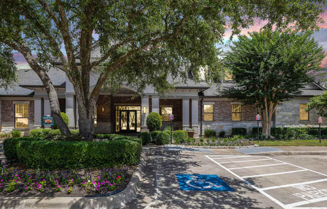 a parking lot in front of a building with trees at The Vista on Brodie, Austin