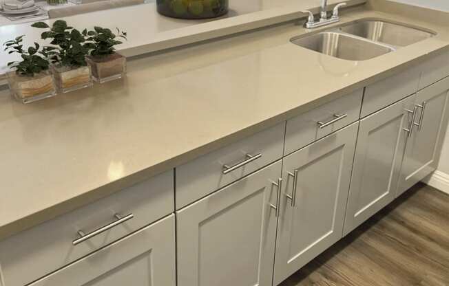 a kitchen with white cabinets and a sink