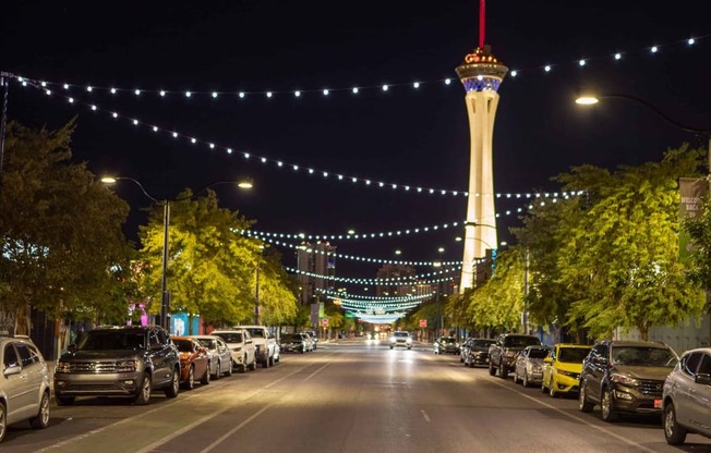 a city street at night with the stratosphere tower and lights