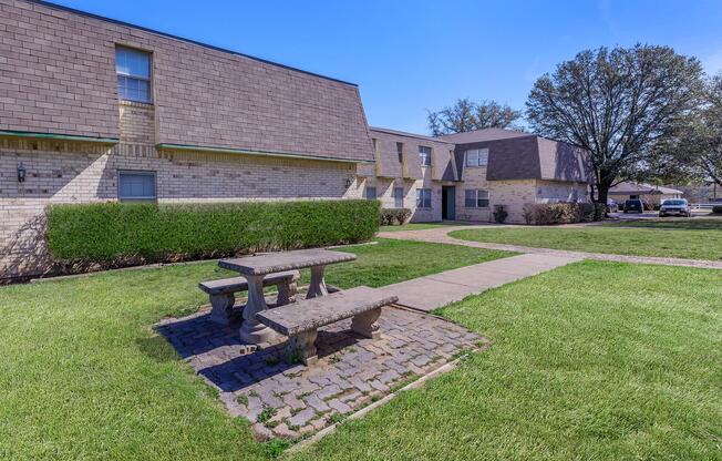 a large lawn in front of a brick building