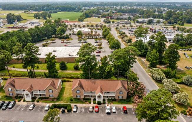 an aerial view of a neighborhood with houses and parking lot