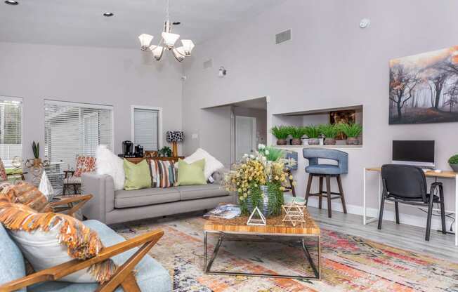 Living room with couch and tv and open kitchenat Royal Wildewood Manor Apartments, Clute, Texas