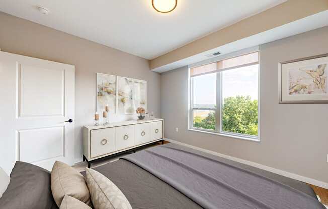 a bedroom with a large bed and a window