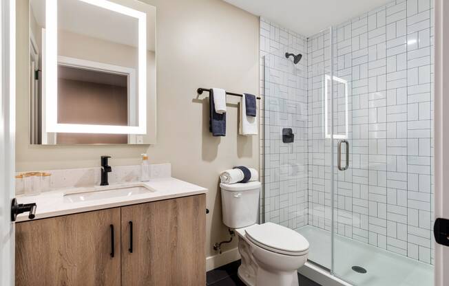 a bathroom with a toilet sink and shower