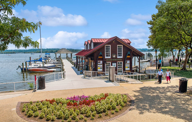 a marina with boats and a building on the water