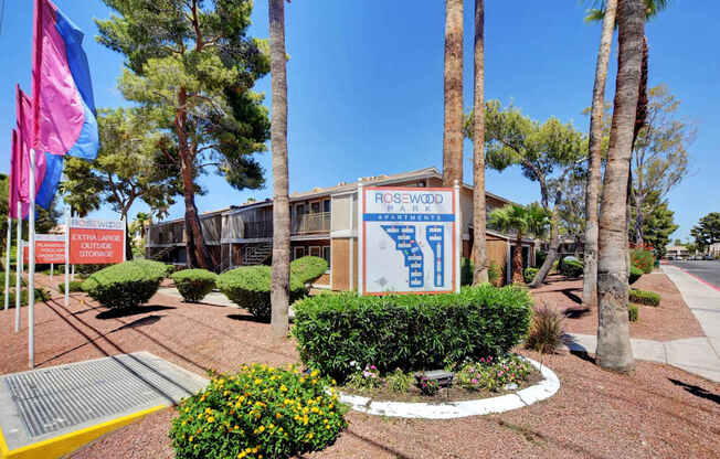 A sign for Rosewood Park is displayed in front of a building.