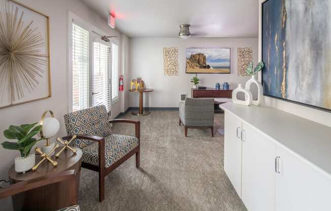 a living room with a dining room table and chairs and a kitchen