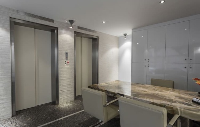 a meeting room with a wooden table and white chairs