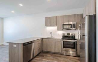 a kitchen with stainless steel appliances and wooden cabinets