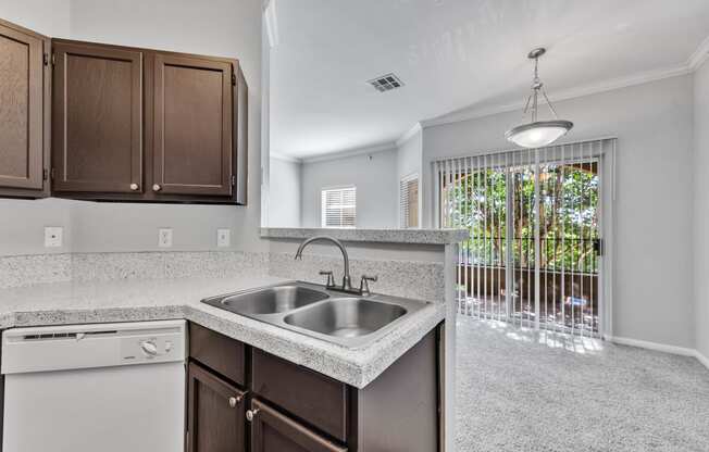 an empty kitchen with a sink and a window