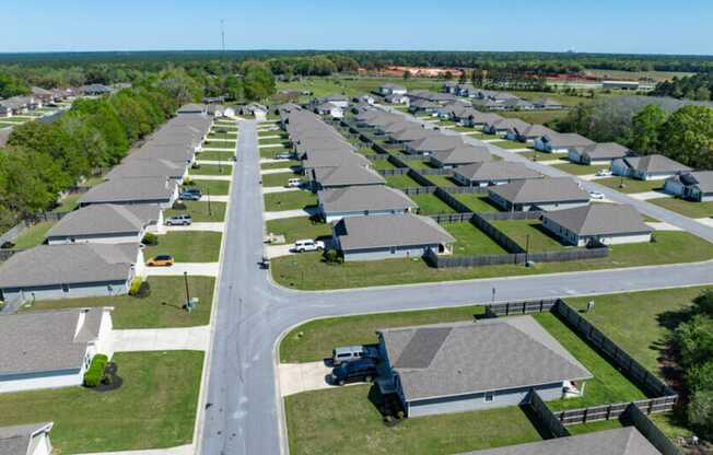 an aerial view of a row of houses in a parking lot