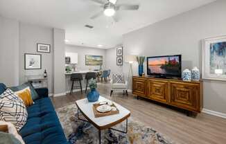 a living room with a blue couch and a tv