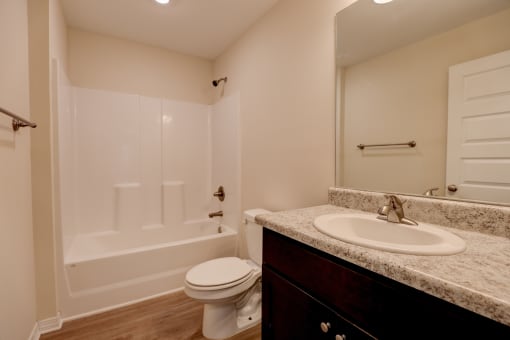 a bathroom with a sink toilet and mirror