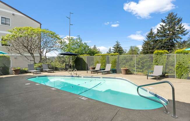A small pool with a metal fence around it.