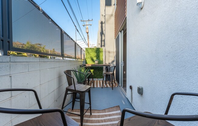a balcony or terrace with chairs and a table