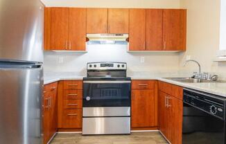 a kitchen with stainless steel appliances and wooden cabinets