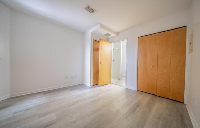 A room with a white wall and a wooden floor.