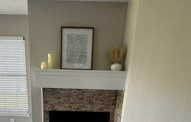 A room with a window and a picture on the wall.