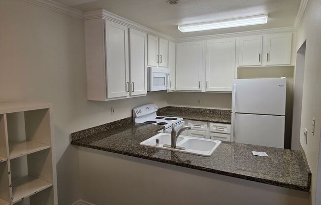 Renovated upstairs 2 bedroom 2 bath condo in a gate community available now