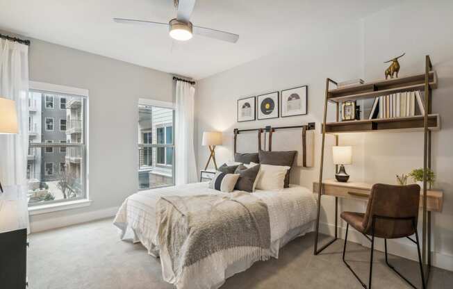 a bedroom with a bed and a large window