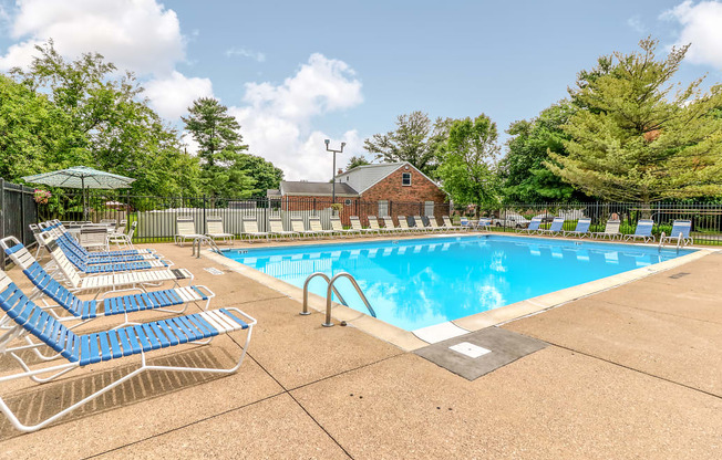 Outdoor swimming pool with seating at Ashley Pointe Apartments