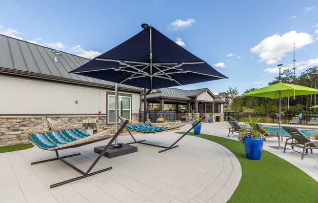 Poolside lounge chairs and hammocks at Evergreen at Southwood in Tallahassee, FL