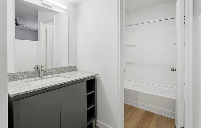A bathroom with a sink and a mirror.