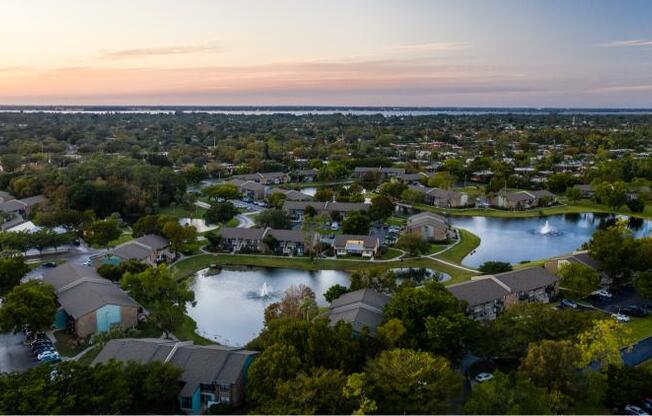 an aerial view of a neighborhood with a lake and houses