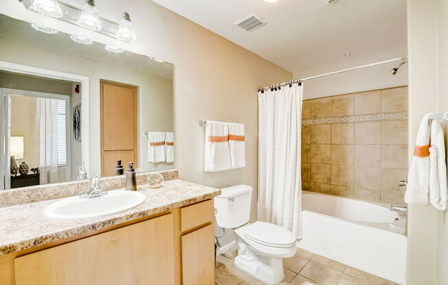 a bathroom with a sink toilet and a tub at Adiamo Palm Valley, Goodyear