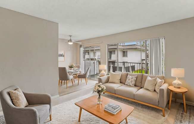 A living room with a grey couch, a wooden coffee table, and a grey armchair.