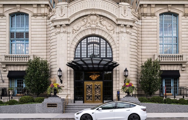a white car parked in front of a building  at The Belden Stratford, Chicago, Illinois