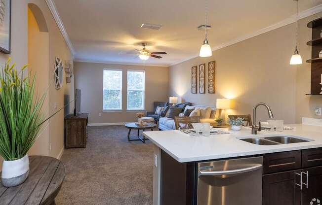 A kitchen with a dining table and chairs in the background.