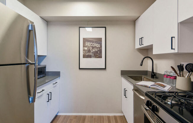 Galley style kitchen with chic white cabinets