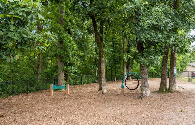 a playground with trees and a bike in the middle