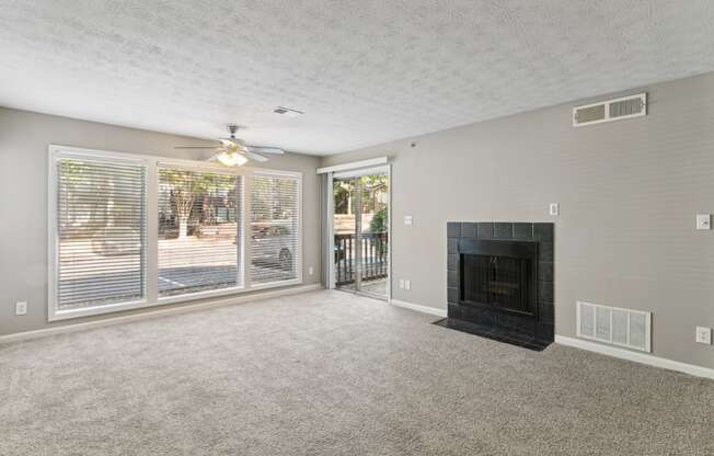 Bright living room with a fireplace and a ceiling fan at Oakley Run apartments in Smyrna, GA