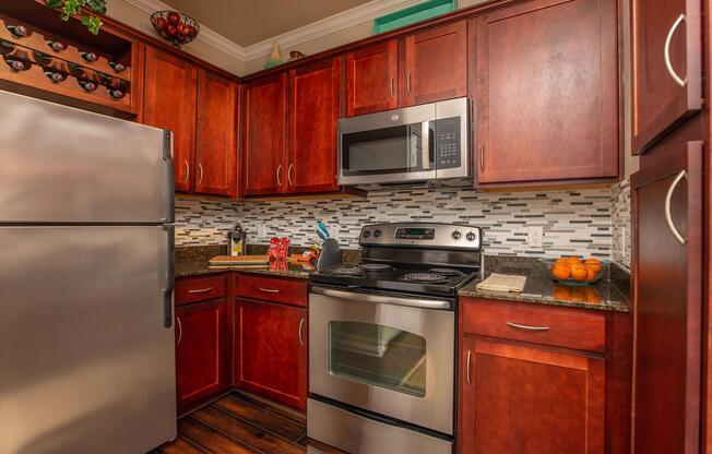 a kitchen with stainless steel appliances and wooden cabinets