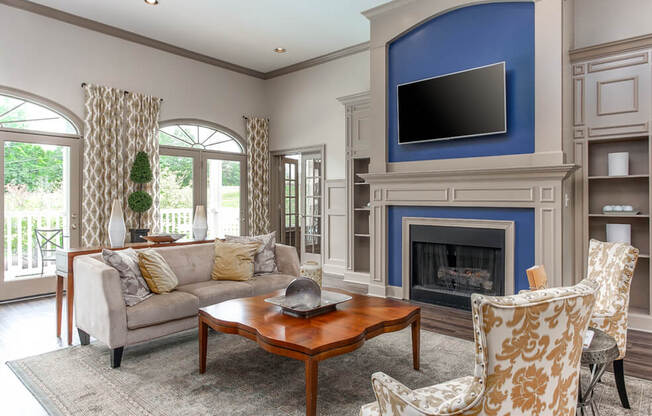 A living room with a fireplace and a television.