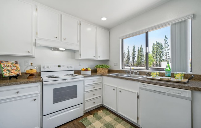 a white kitchen with white appliances and white cabinets